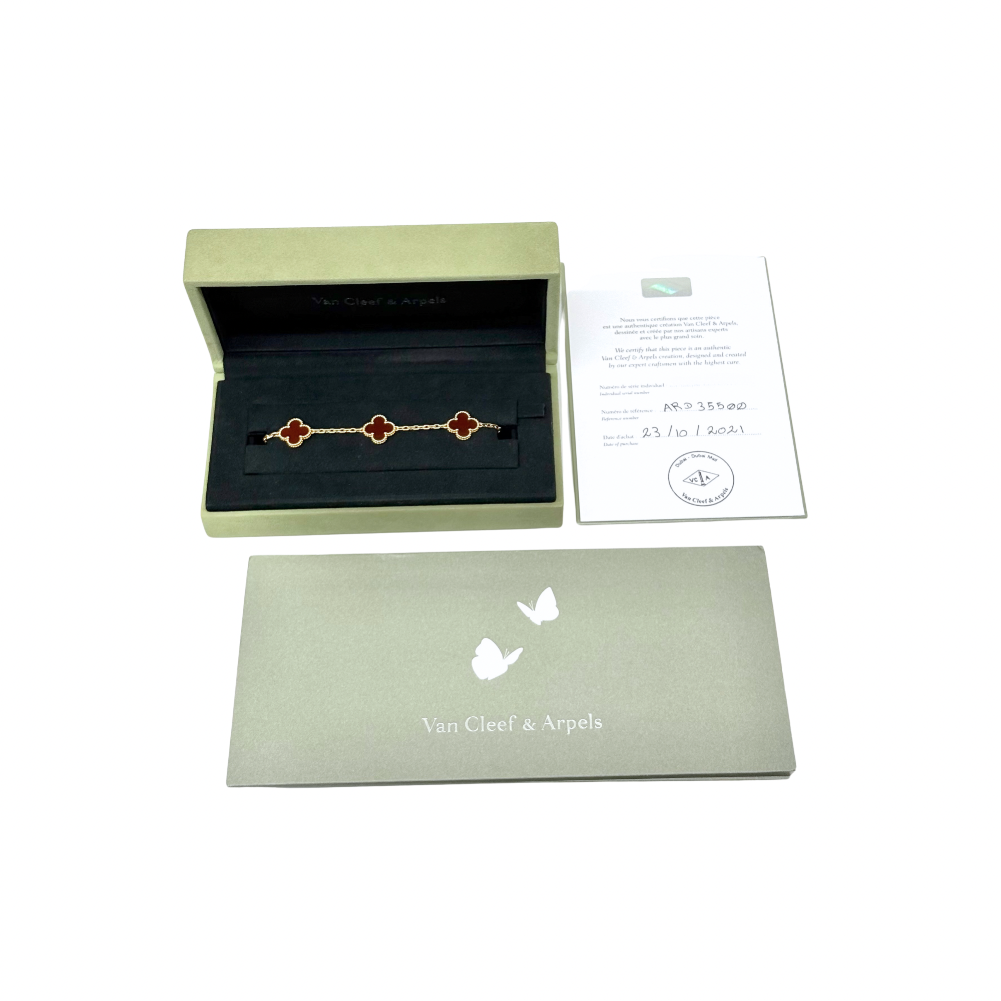 Goldtone bracelet with five red clover motifs, linked chain