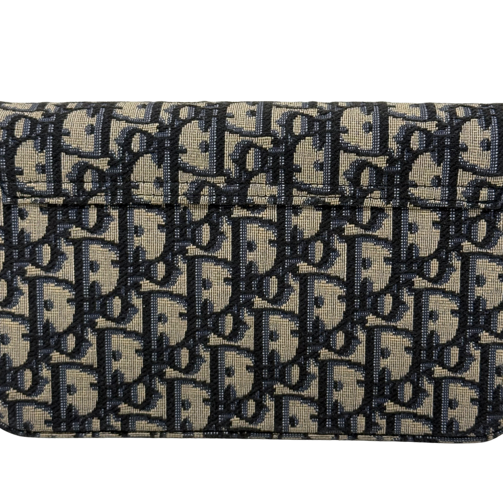 Dior monogram canvas close-up with flap edge stitching and dark repeating pattern