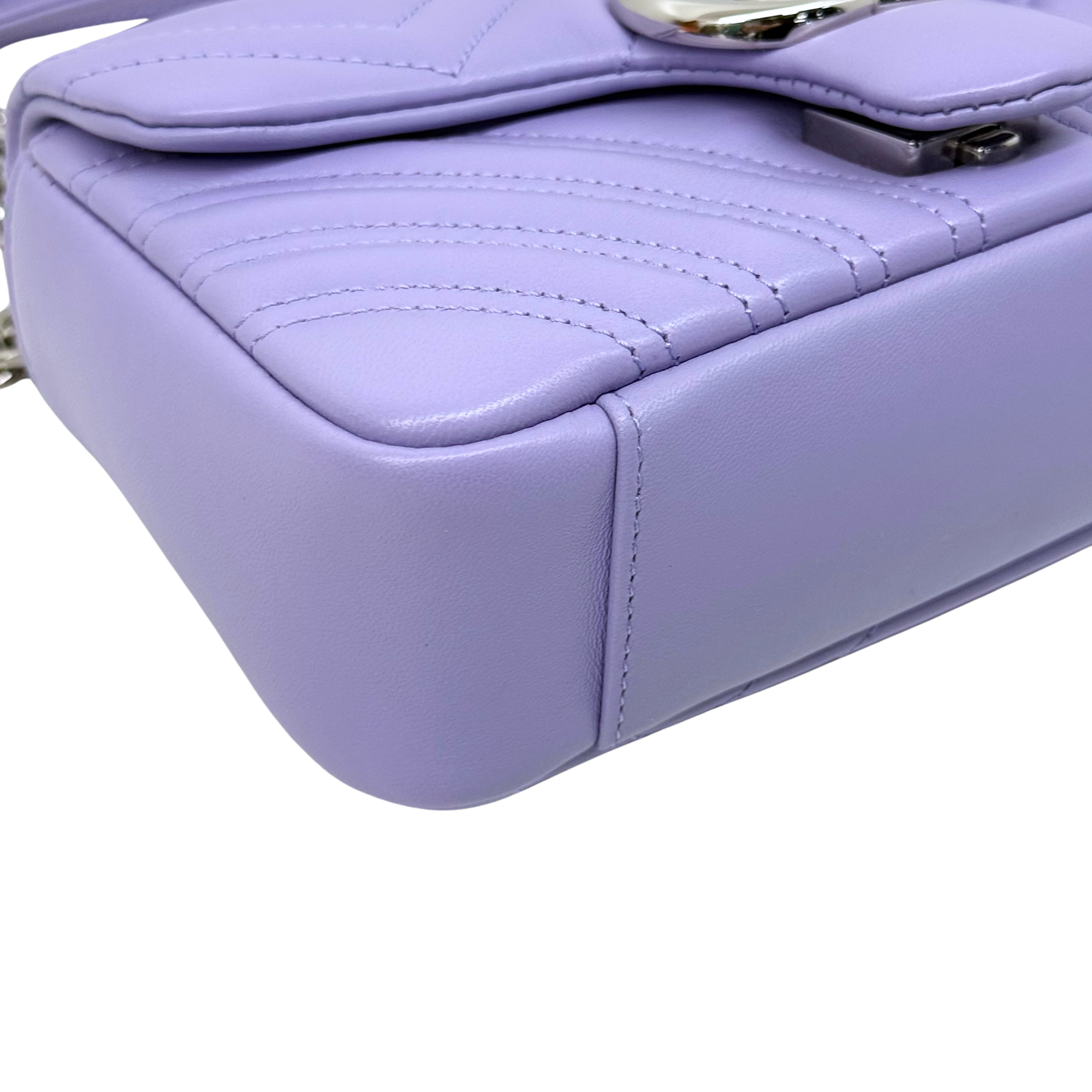 Lavender quilted mini bag corner with stitched edge and metal clasp hardware