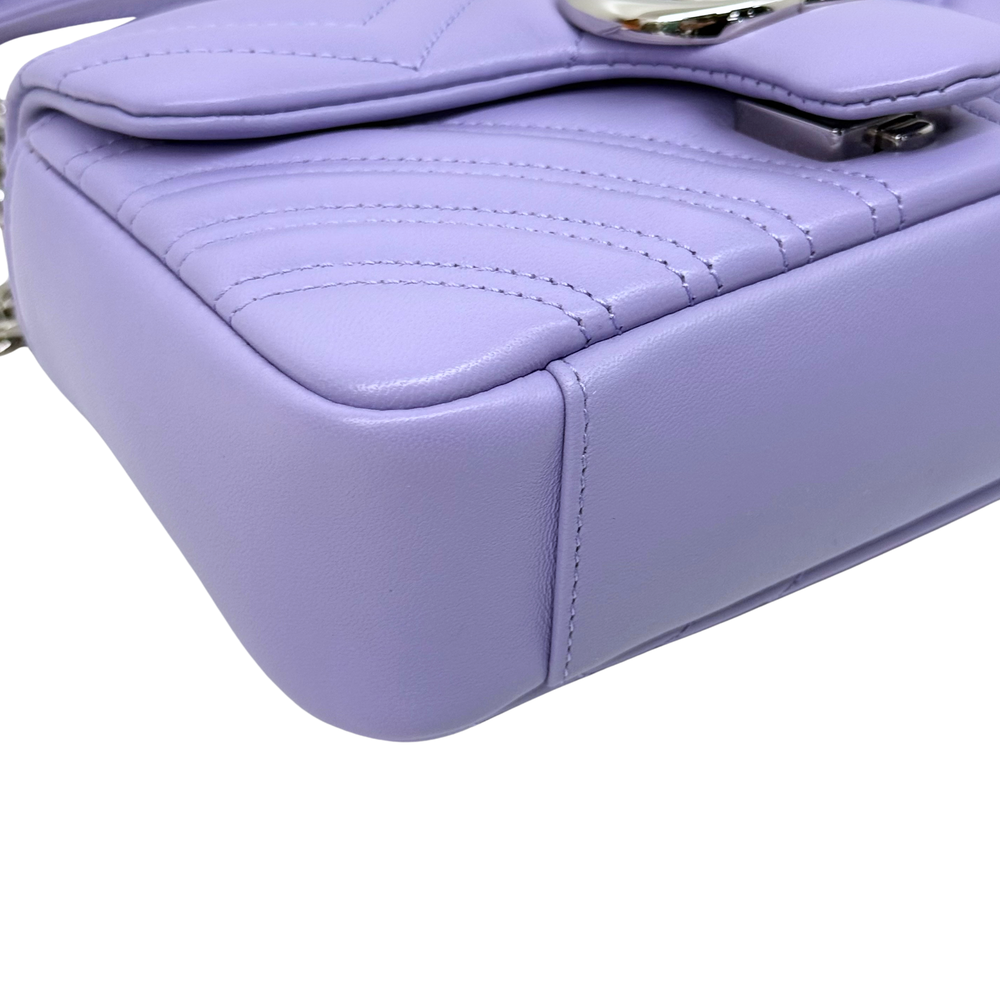 Lavender quilted mini bag corner with stitched edge and metal clasp hardware