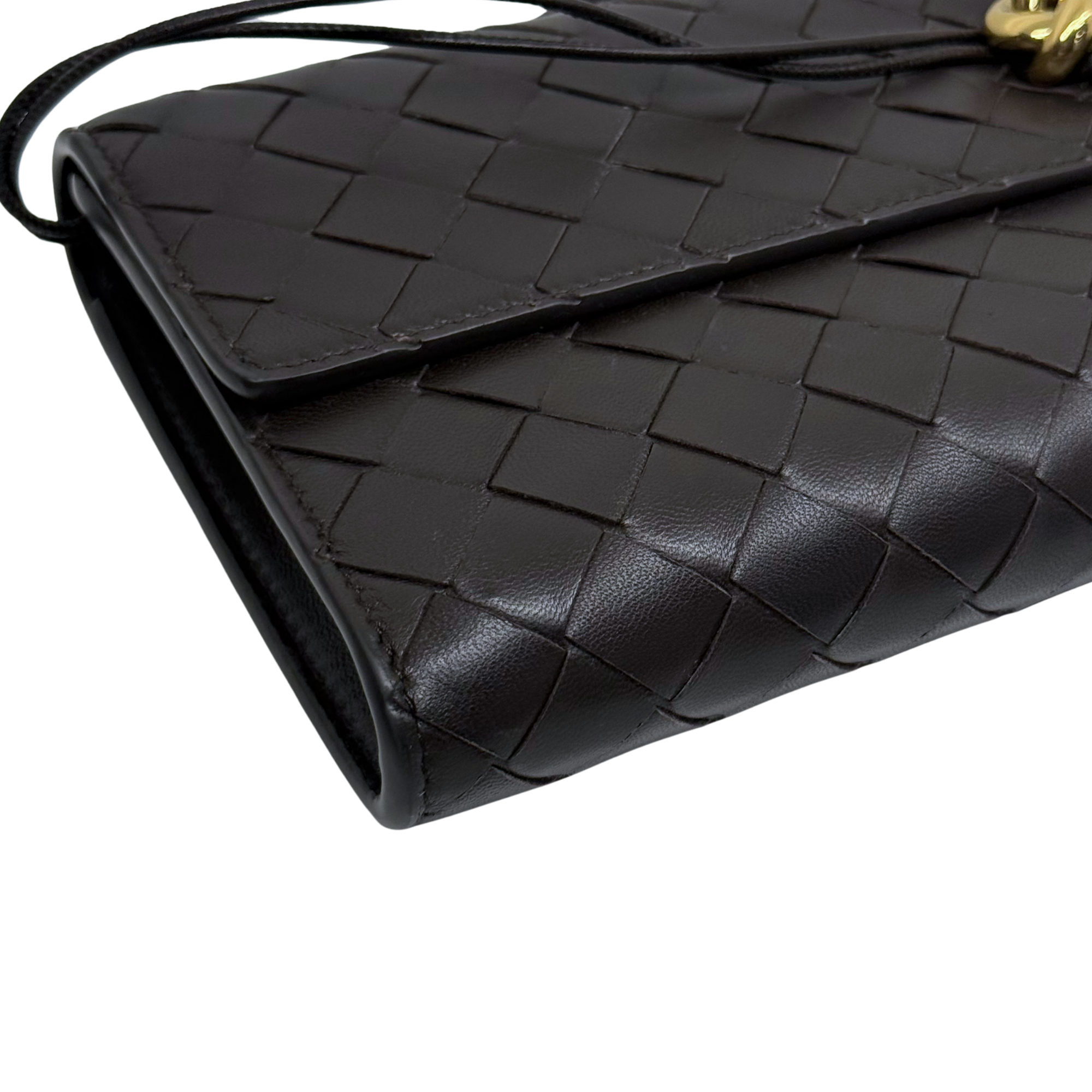 Black woven leather corner with stitched edge and subtle scuffs