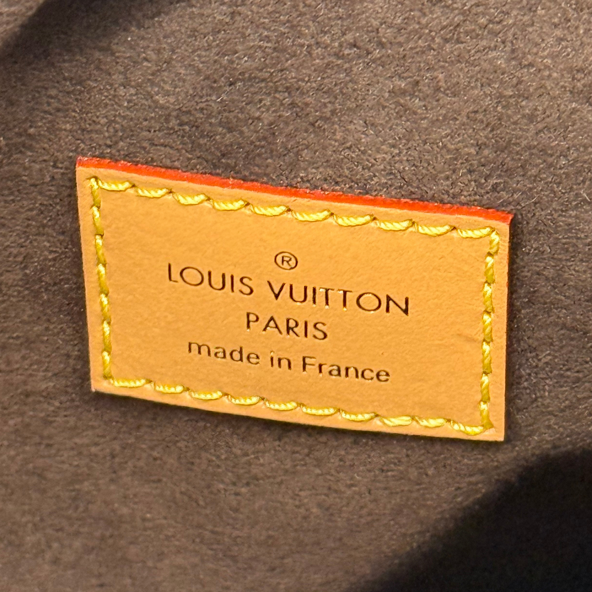 Pre-owned Louis Vuitton bag interior label, tan leather with gold stitching and text
