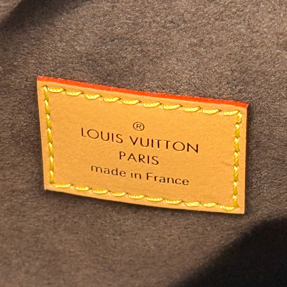 Pre-owned Louis Vuitton bag interior label, tan leather with gold stitching and text