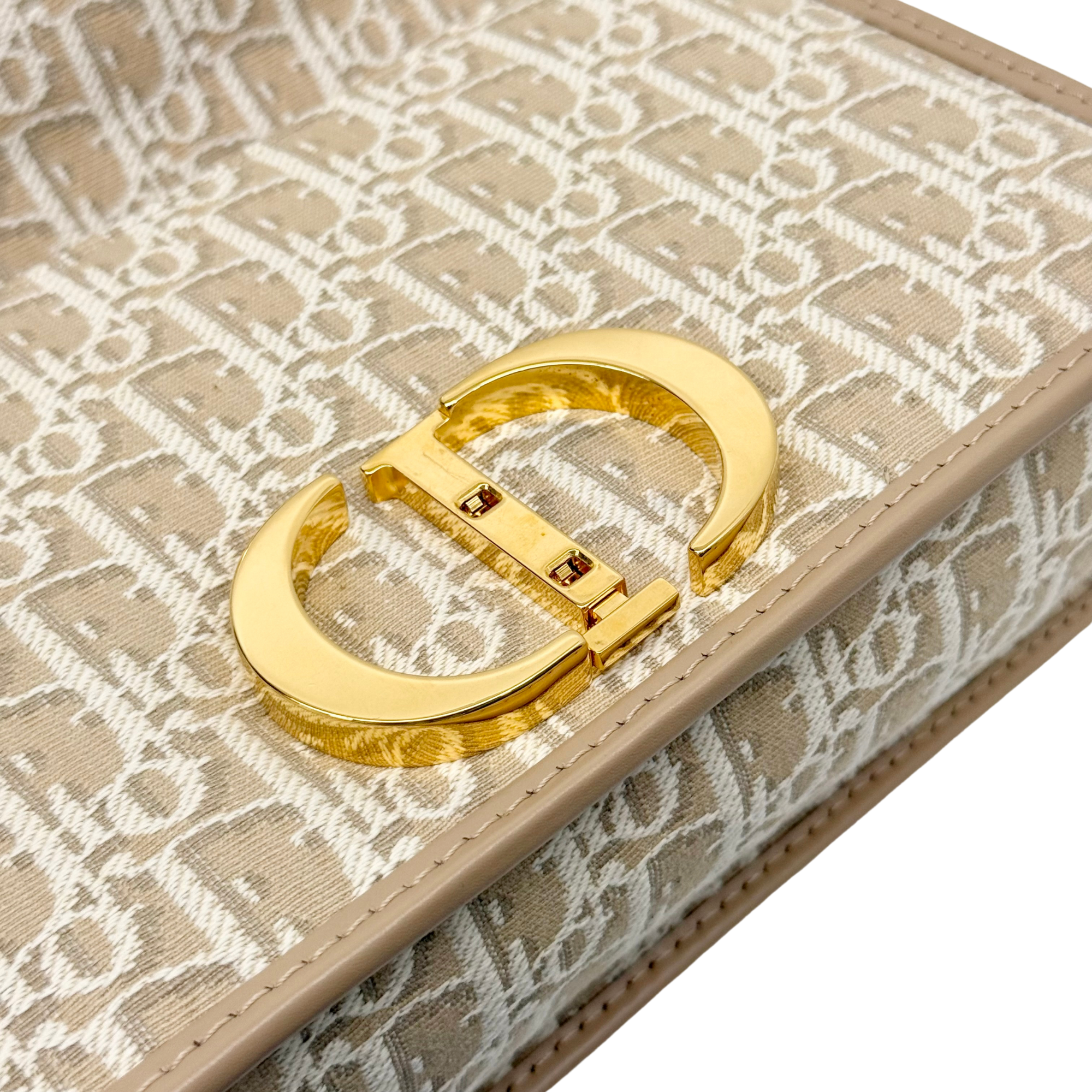 Dior pre-owned bag clasp with oval gold frame on beige monogram canvas