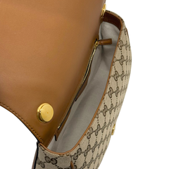 Gucci GG canvas bag interior pocket with brown leather trim and gold snap button