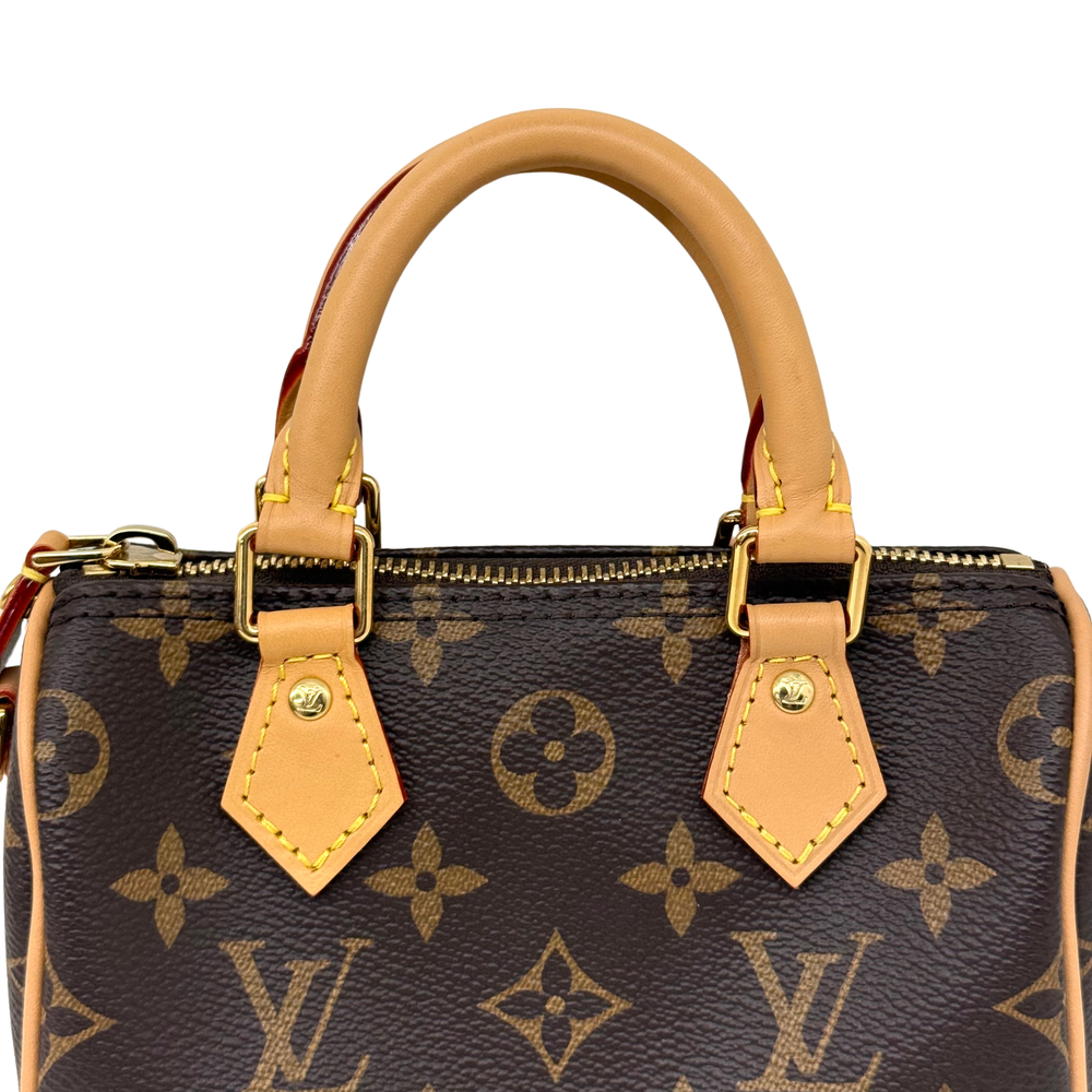 Louis Vuitton monogram handbag top with tan handle tabs and visible zipper