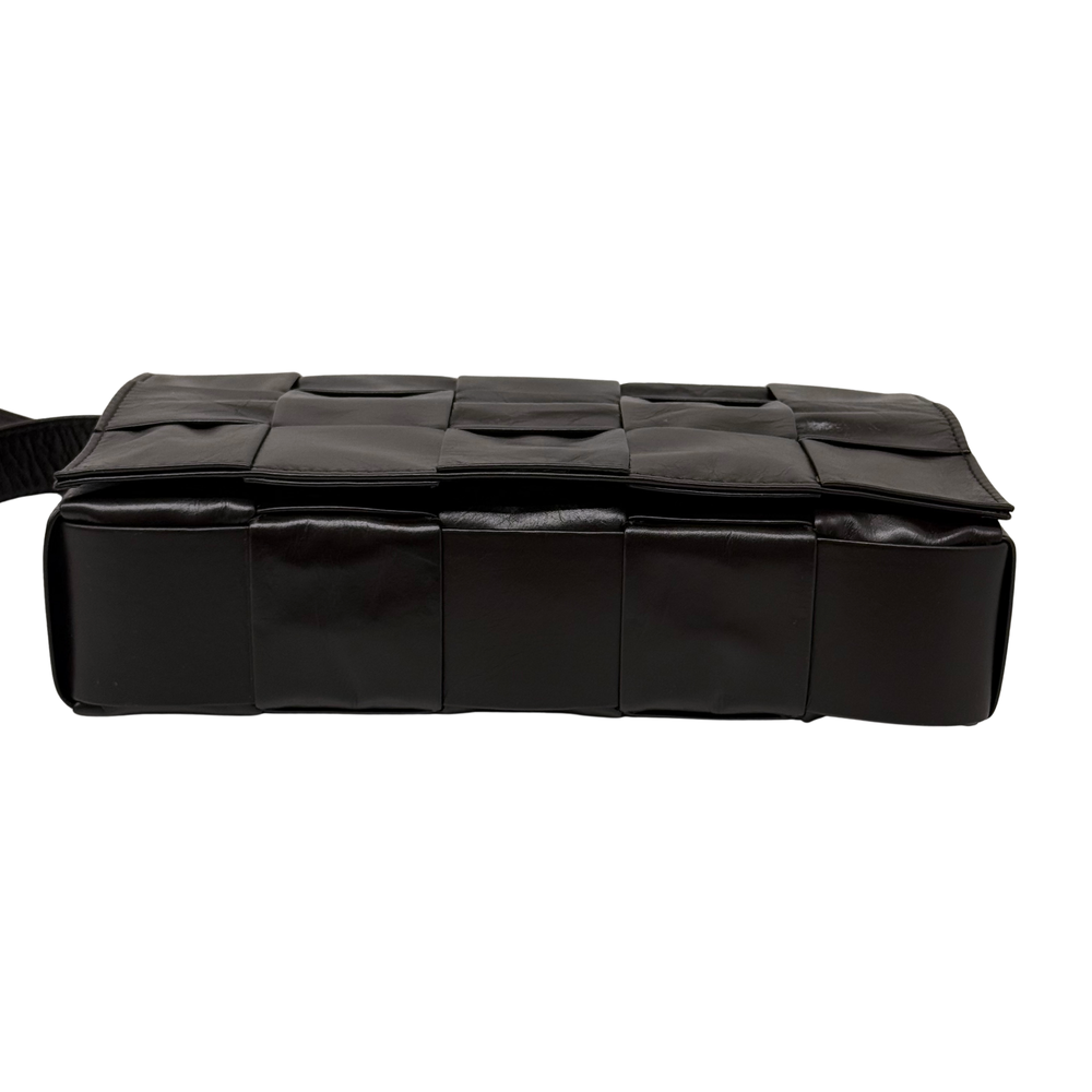 Quilted dark shoulder bag with padded panel blocks and top flap