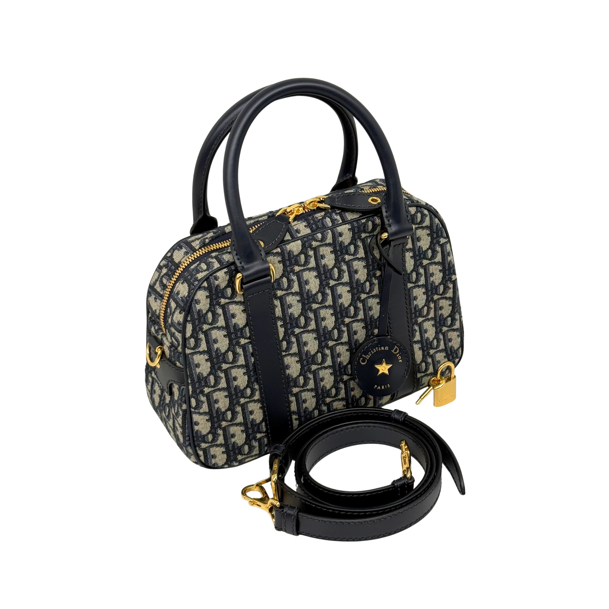 Navy and cream monogram handbag with top handles, crossbody strap, and gold hardware
