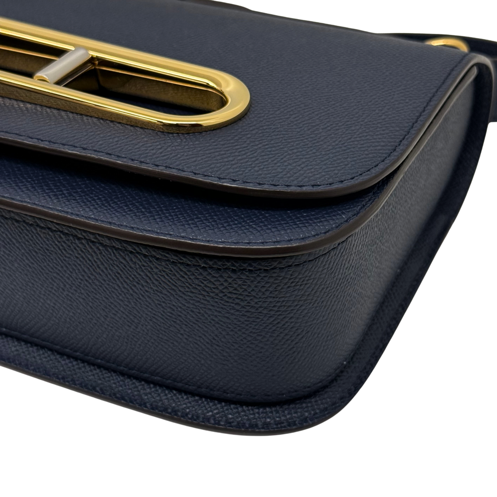 Pre-owned Delvaux bag corner close-up showing flap trim and embossed leather texture