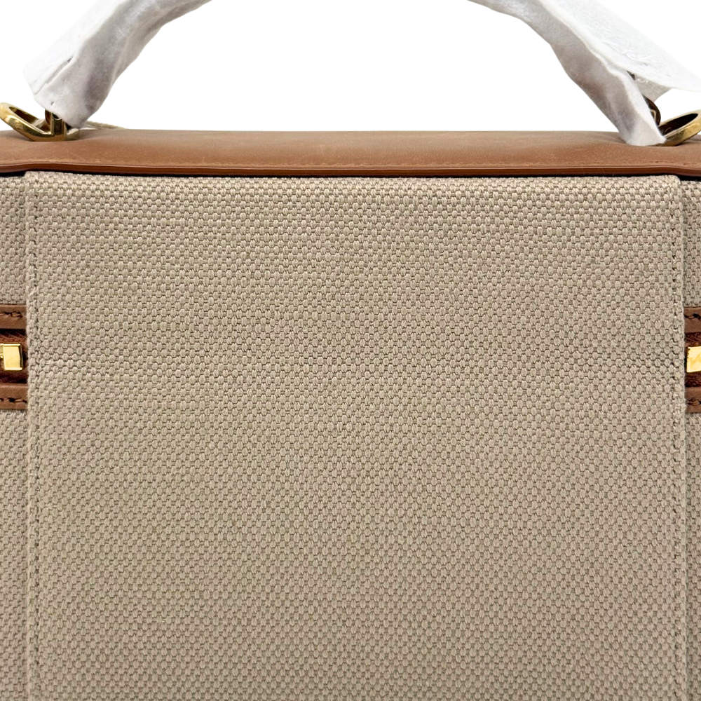 Large beige canvas panel with brown leather top edge and gold zipper rail