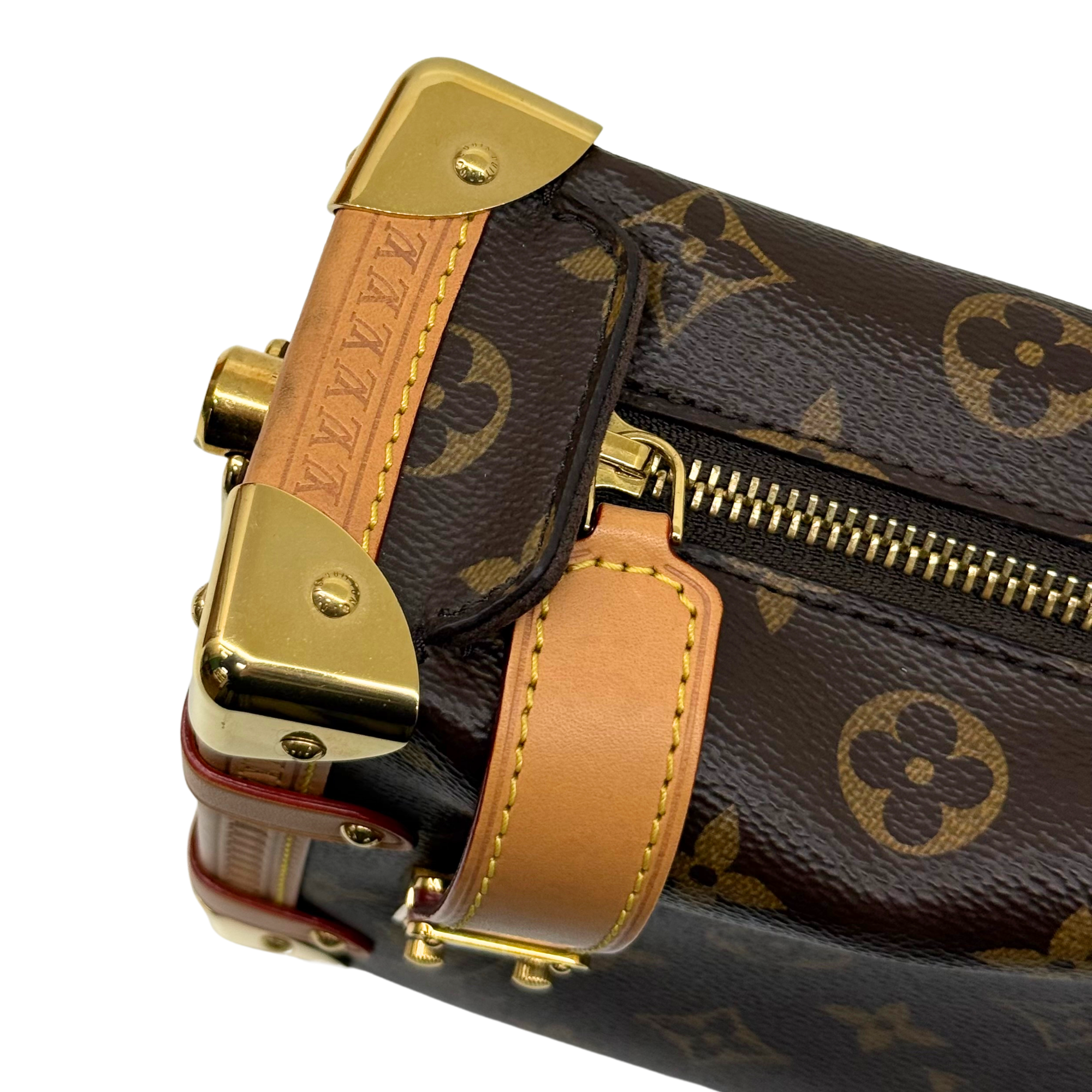 Monogram canvas crossbody bag with gold hardware, tan leather strap, and zipper detail