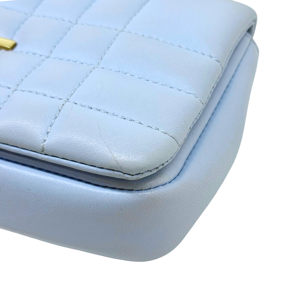Light blue quilted leather corner with curved seam and visible stitching detail.