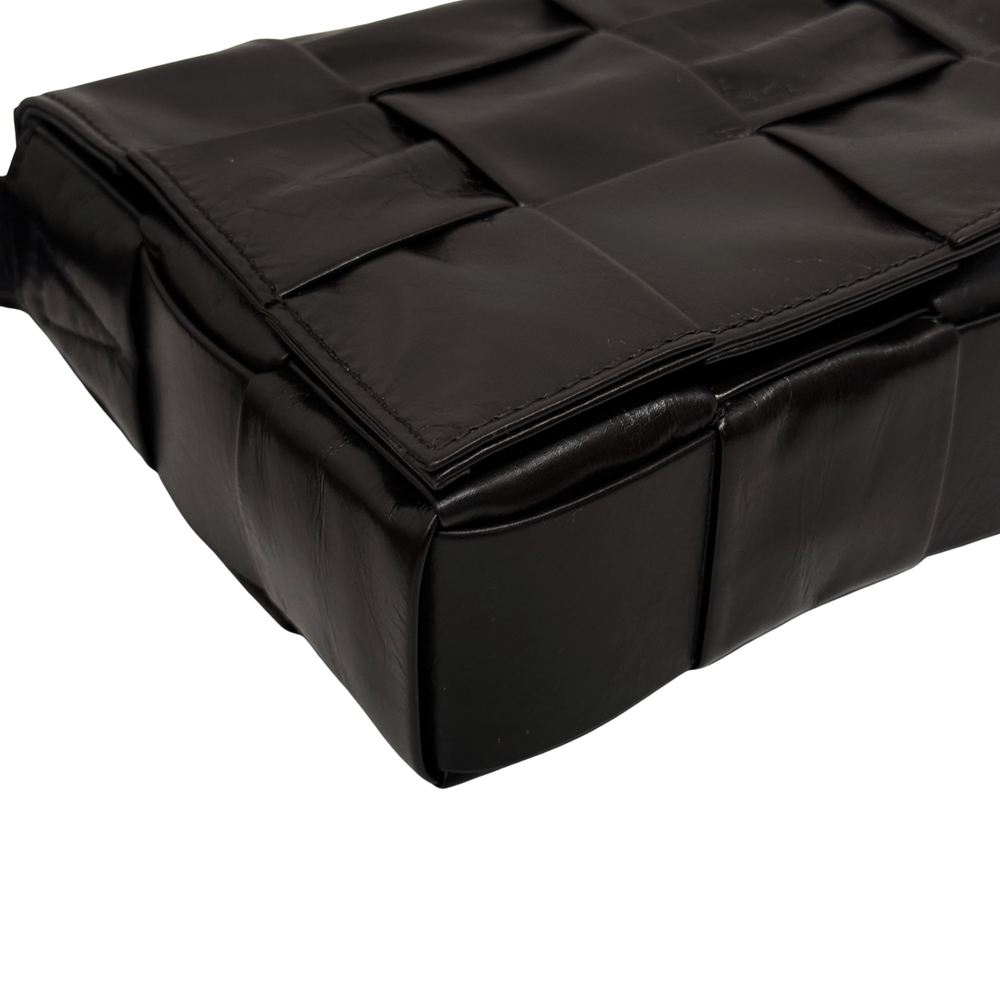 Quilted dark bag with stacked panel design and top flap detail