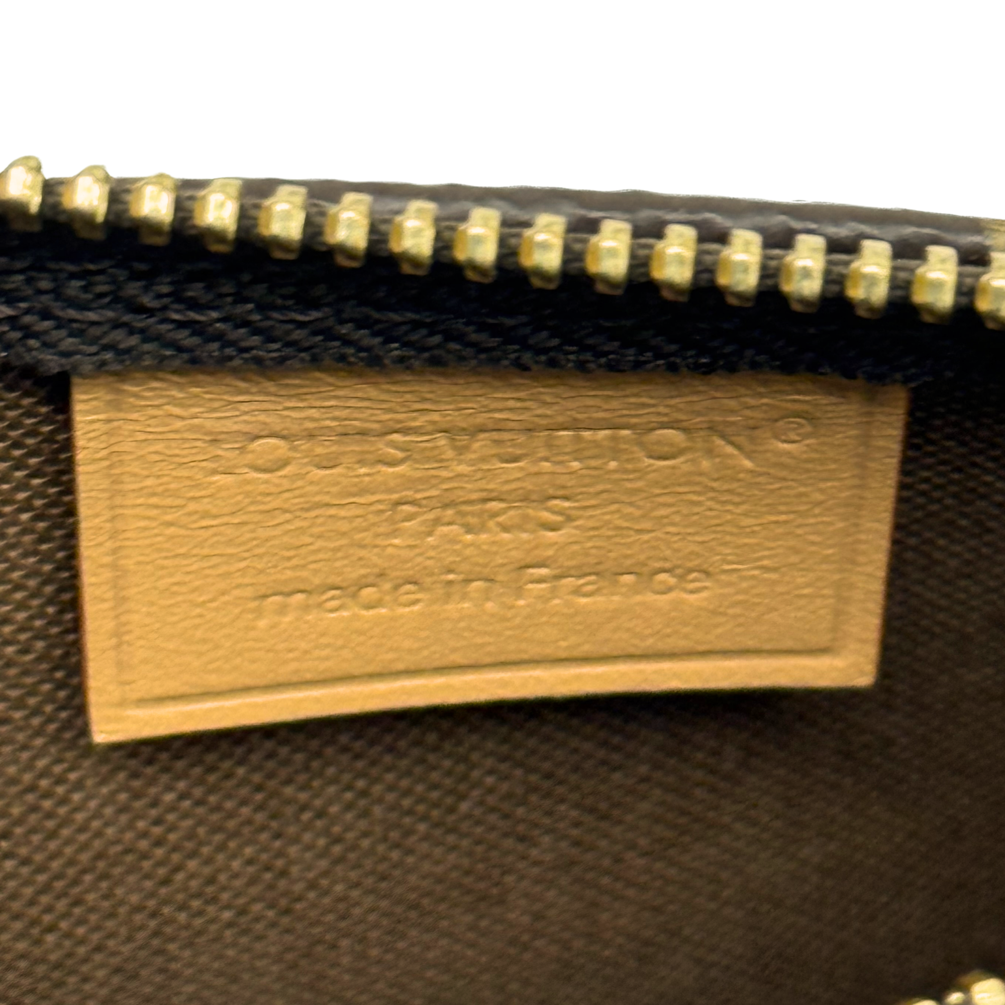 Louis Vuitton interior leather brand label on monogram handbag lining