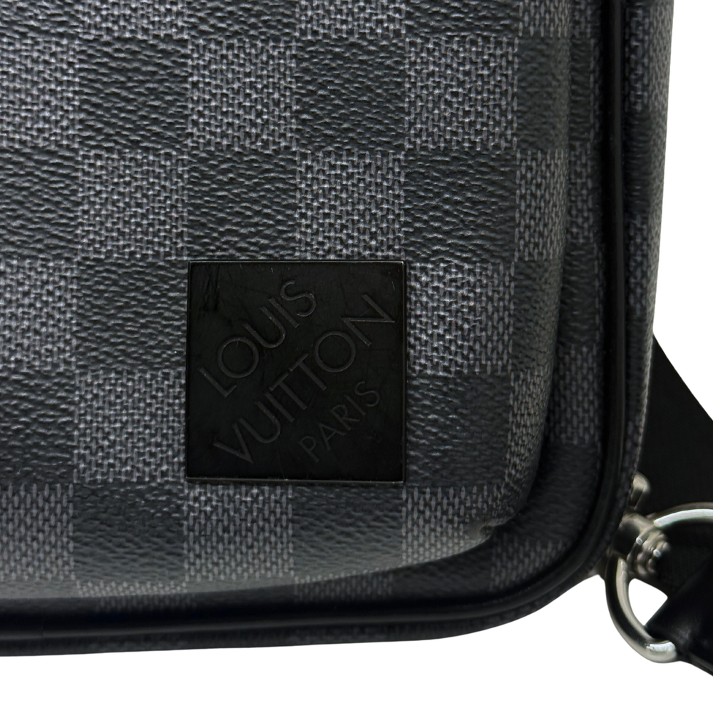 Dark checkered crossbody bag with embossed logo patch and black leather trim