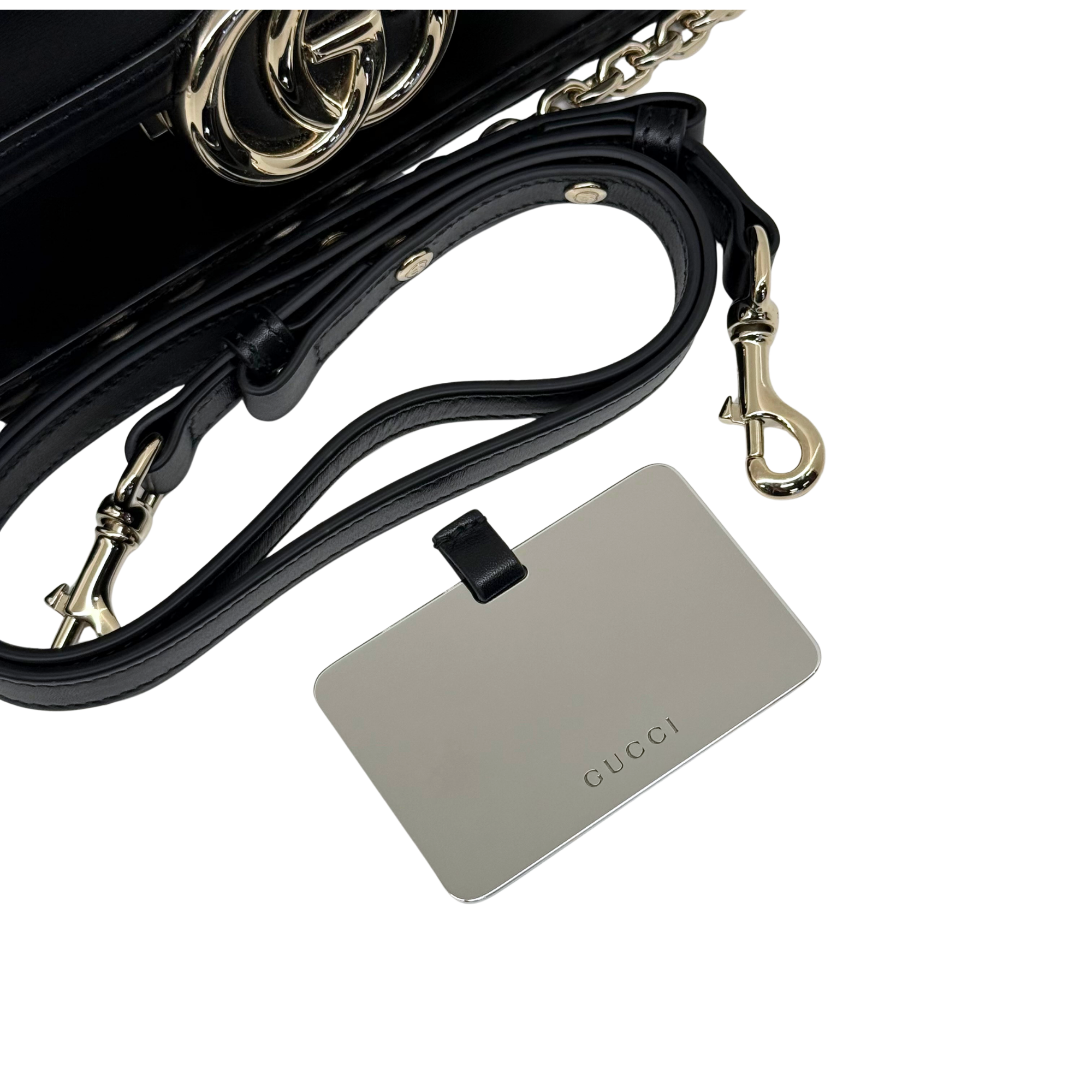 Black leather shoulder bag strap with Gucci tag and gold-tone hardware