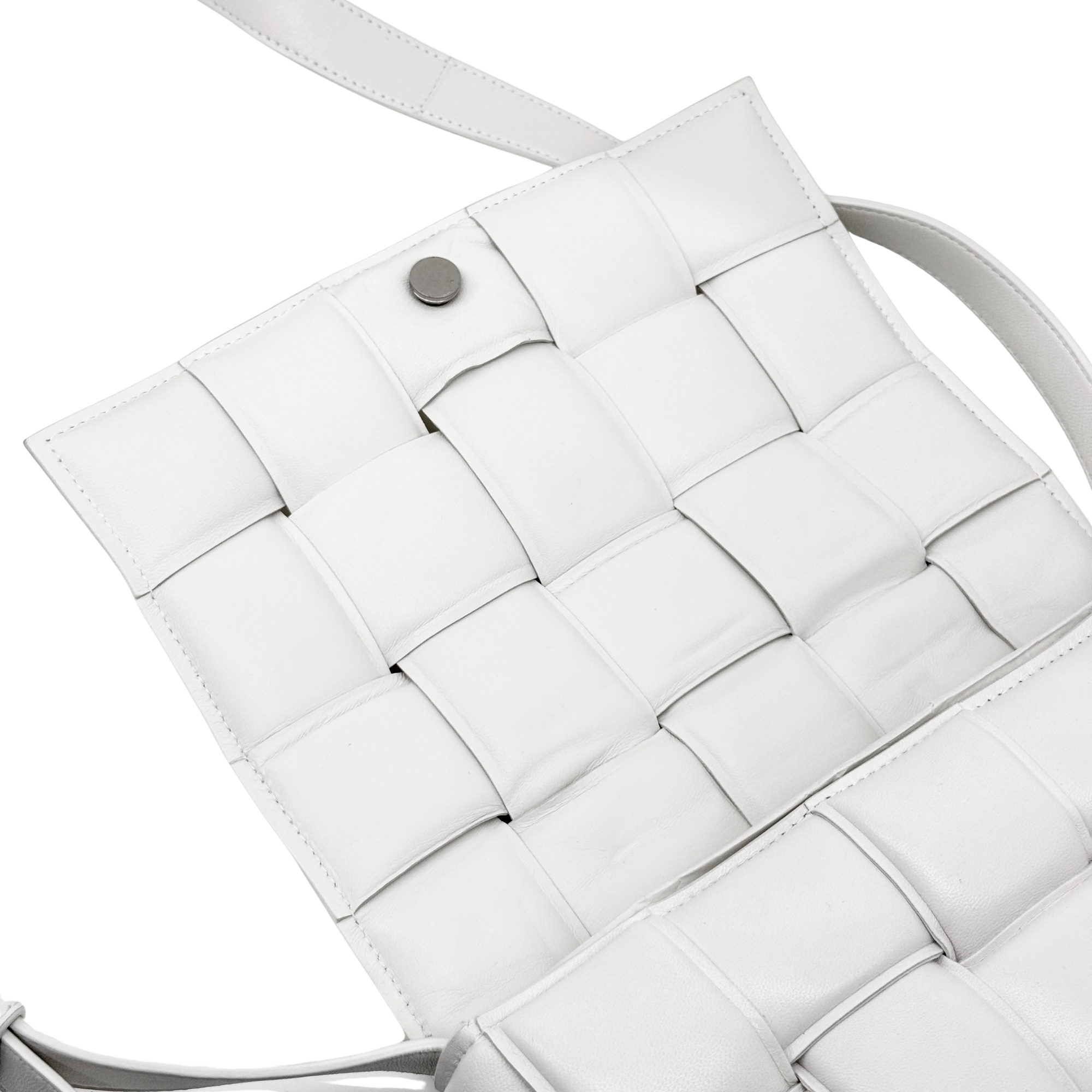 White leather crossbody bag interior panel with stitched grid and snap