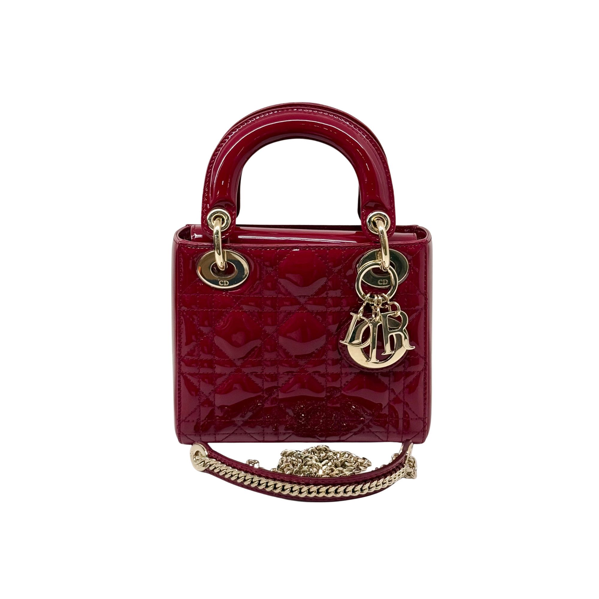 Red patent leather mini handbag with rounded top handles and gold D charm