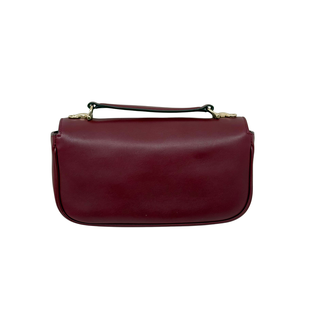 Maroon leather mini bag with top handle and smooth front panel