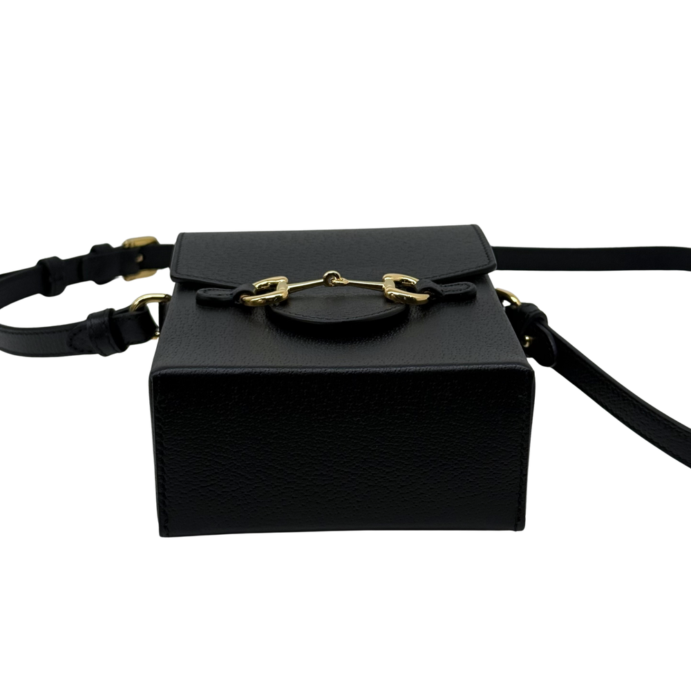Gucci black leather mini crossbody bag with top flap and gold clasp, front view