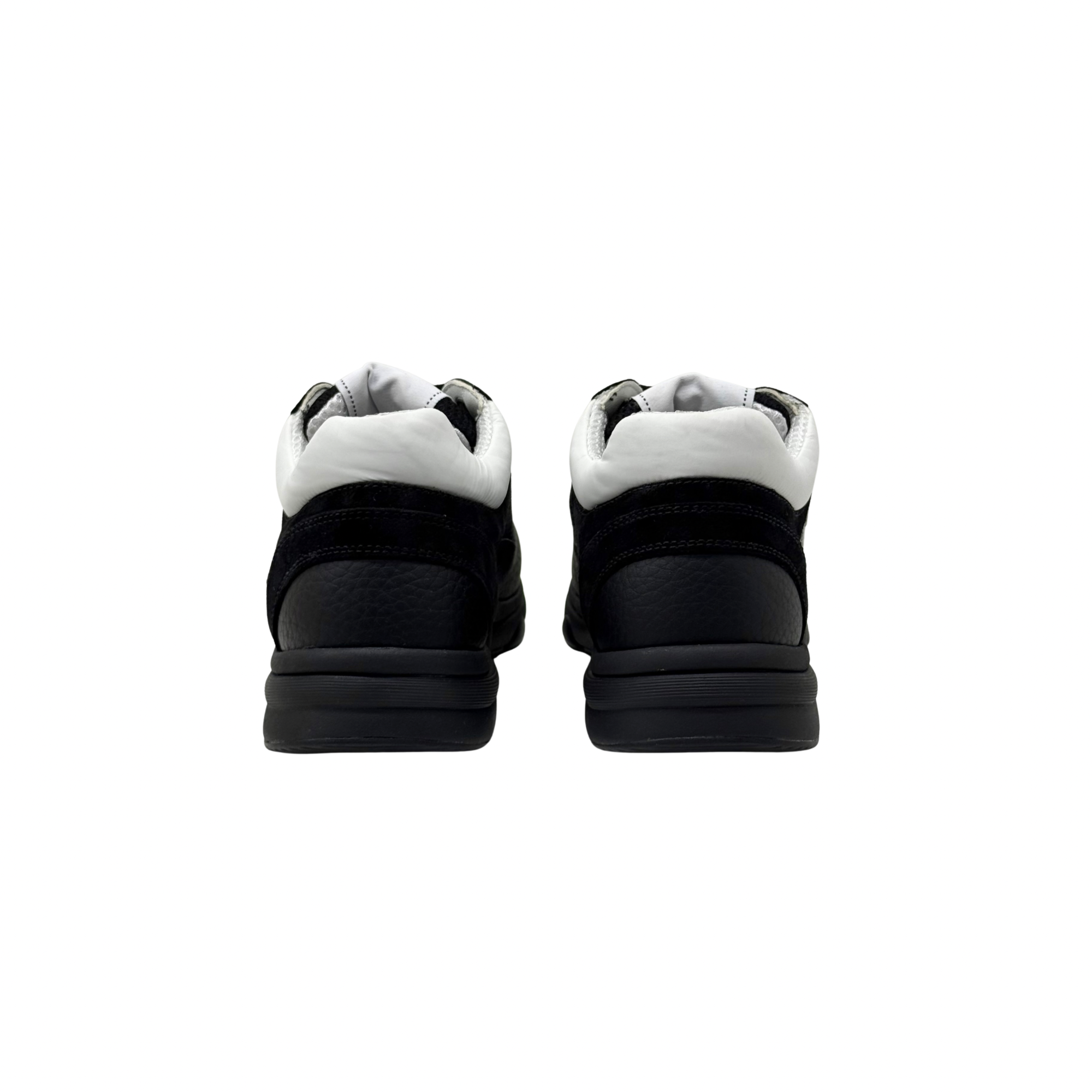 Black low-top sneakers showing heels and padded collars with white lining.