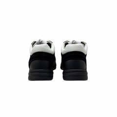 Black low-top sneakers showing heels and padded collars with white lining.