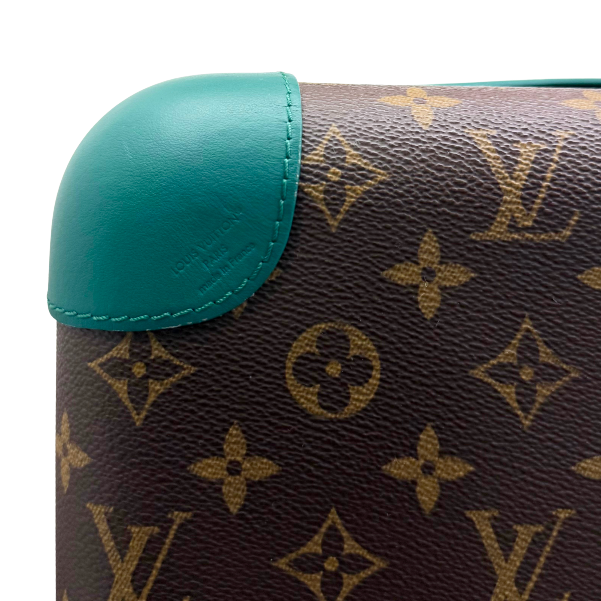 Pre-owned Louis Vuitton trunk suitcase corner close-up, brown monogram canvas and teal leather trim