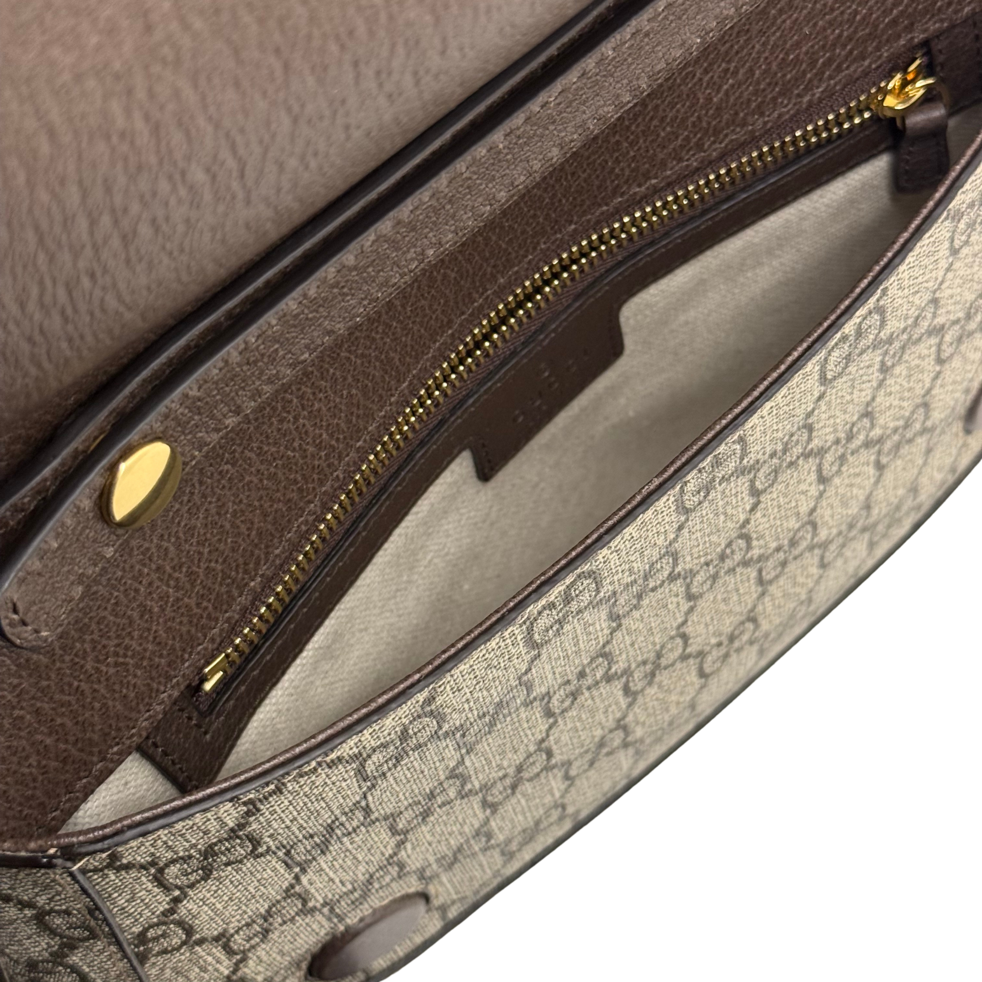 Gucci crossbody bag interior with zip pocket and brown leather trim