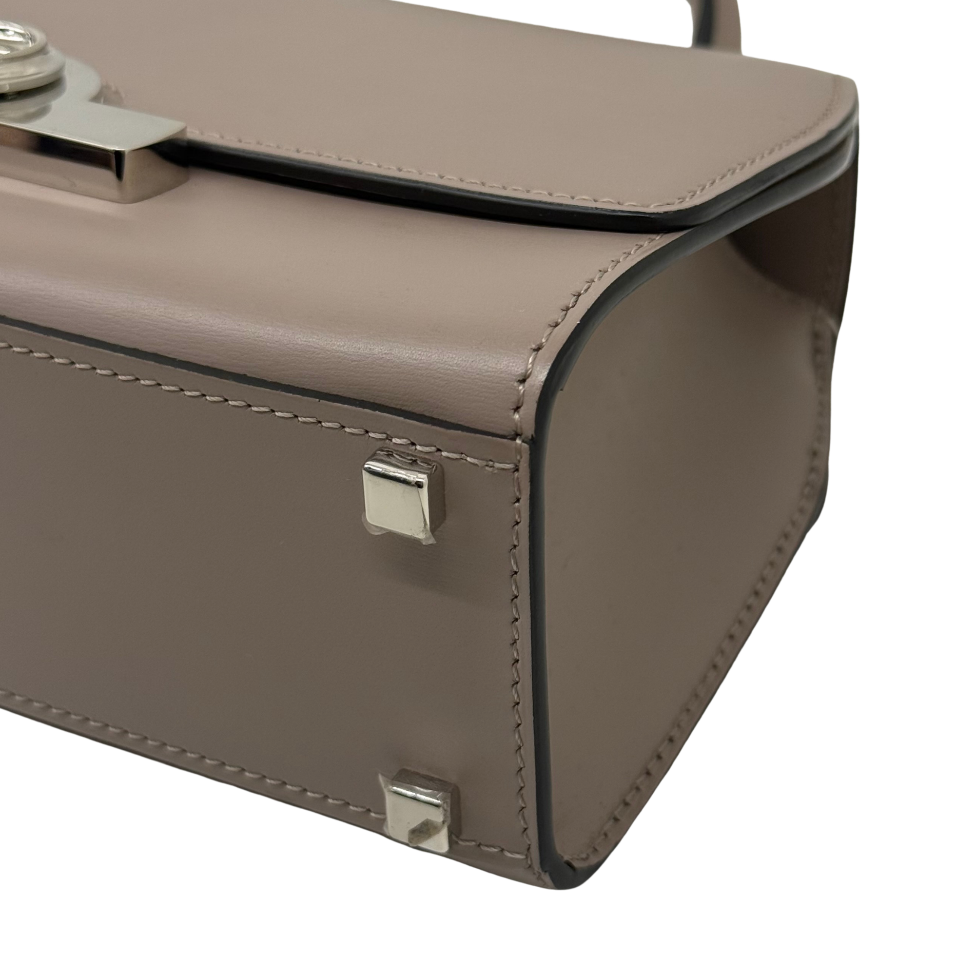 Moynat taupe leather handbag side with front flap catch and stitched edge