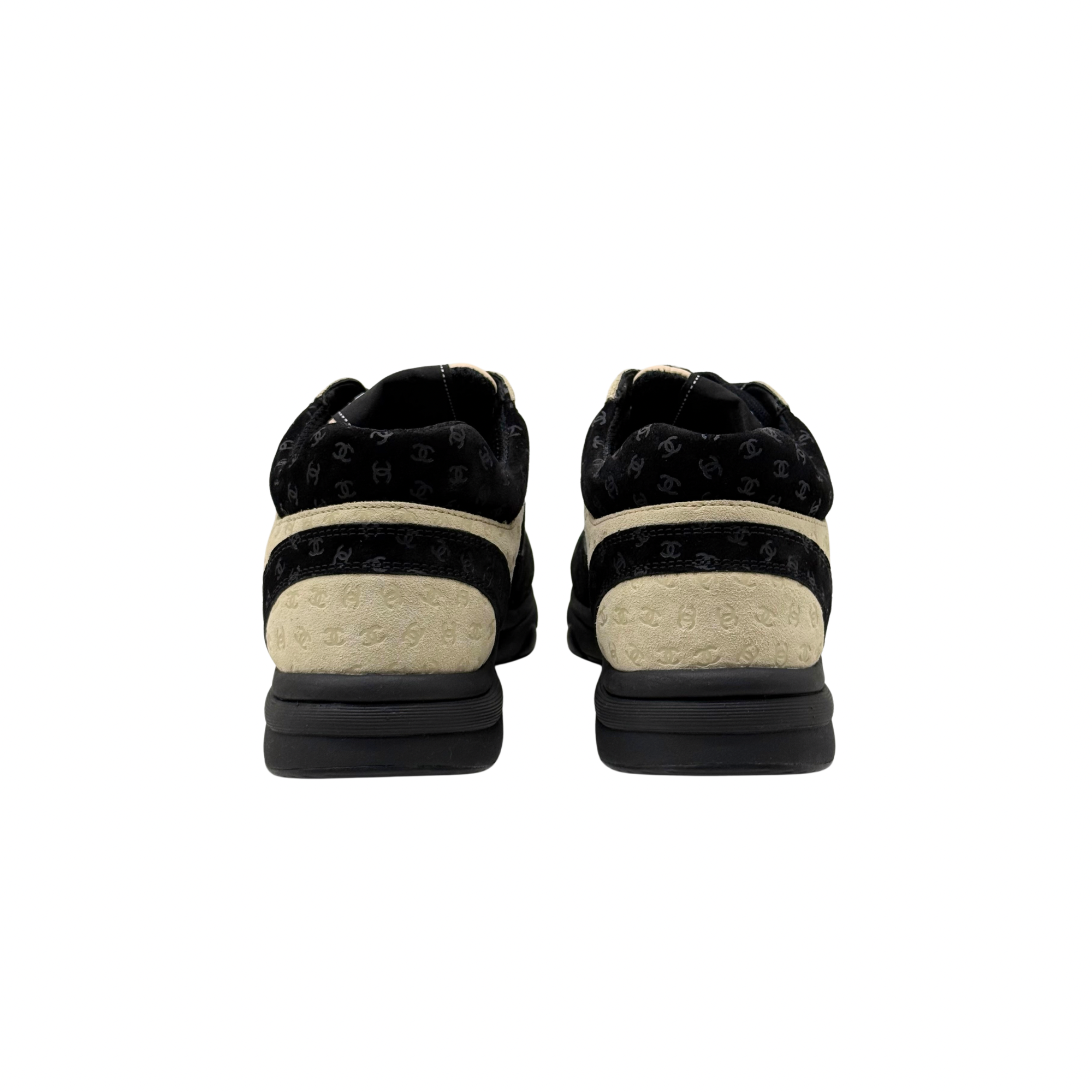 Black and beige Chanel sneakers, back view showing rear counter and rubber sole