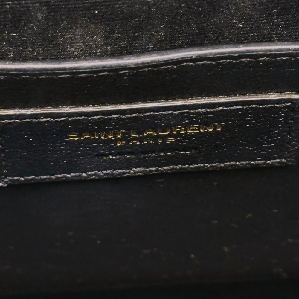 Black leather bag with YSL logo stamp on interior strap