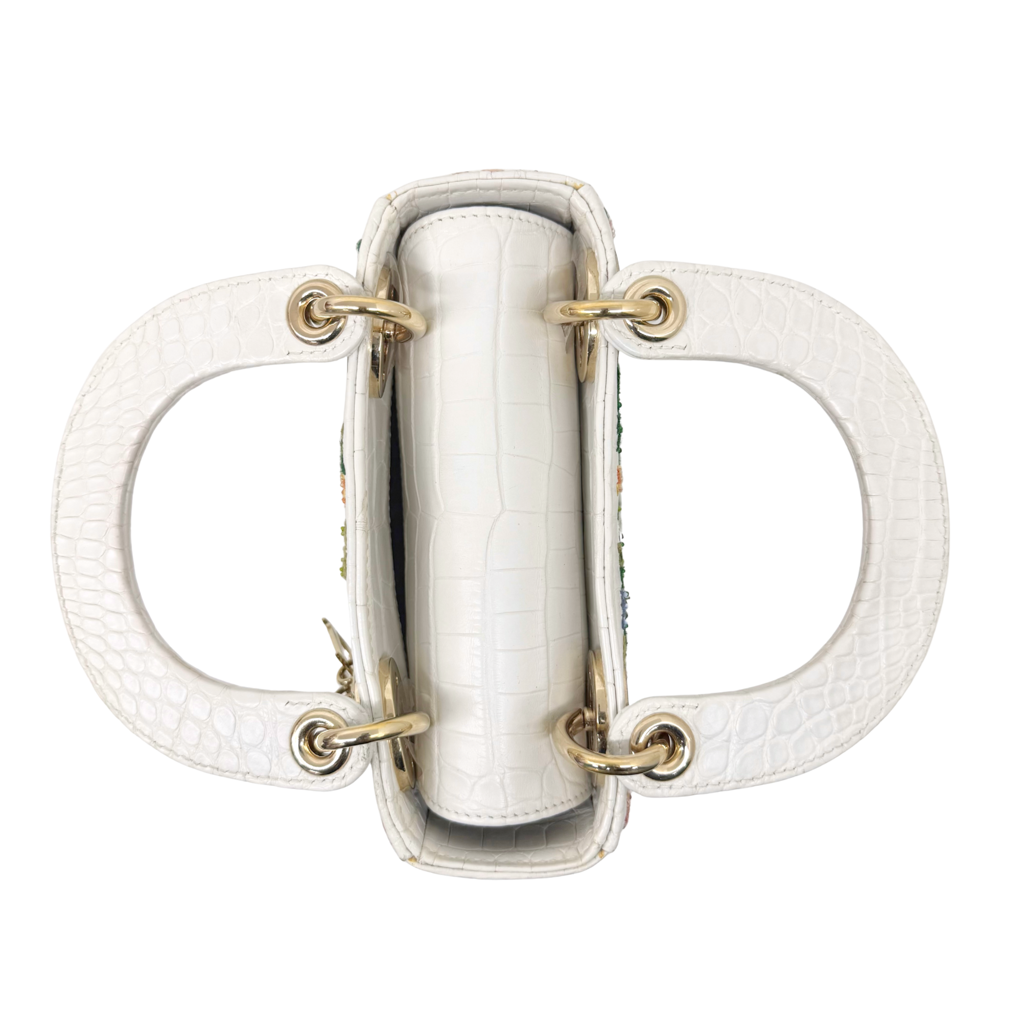 White leather mini handbag top view with double handles and gold hardware