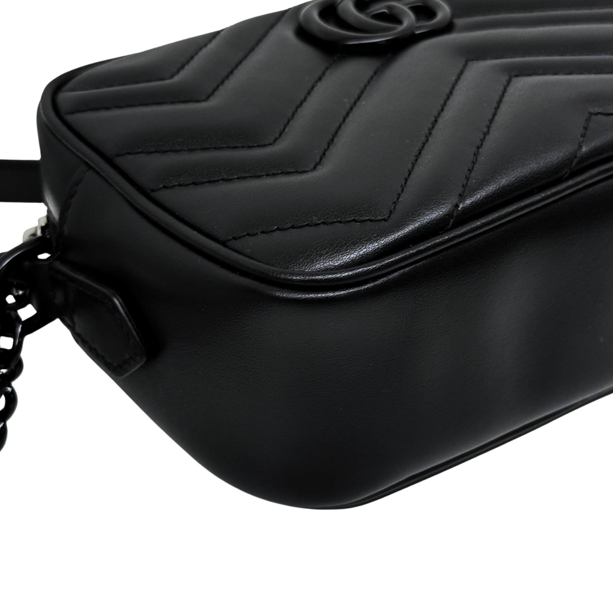 Black leather crossbody bag with quilted chevron stitching and front flap, angled view.