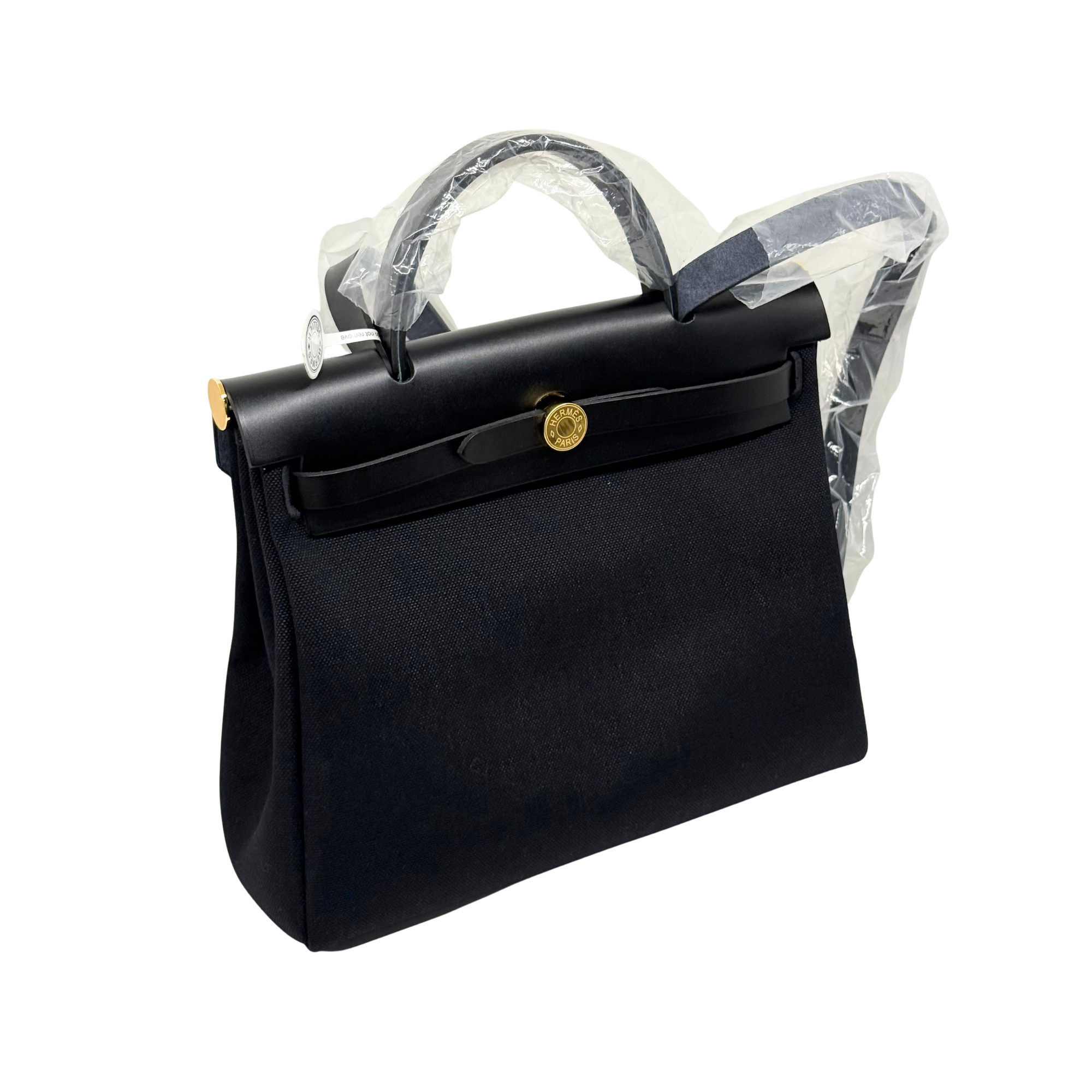 Hermes black handbag side view with front flap and gold hardware