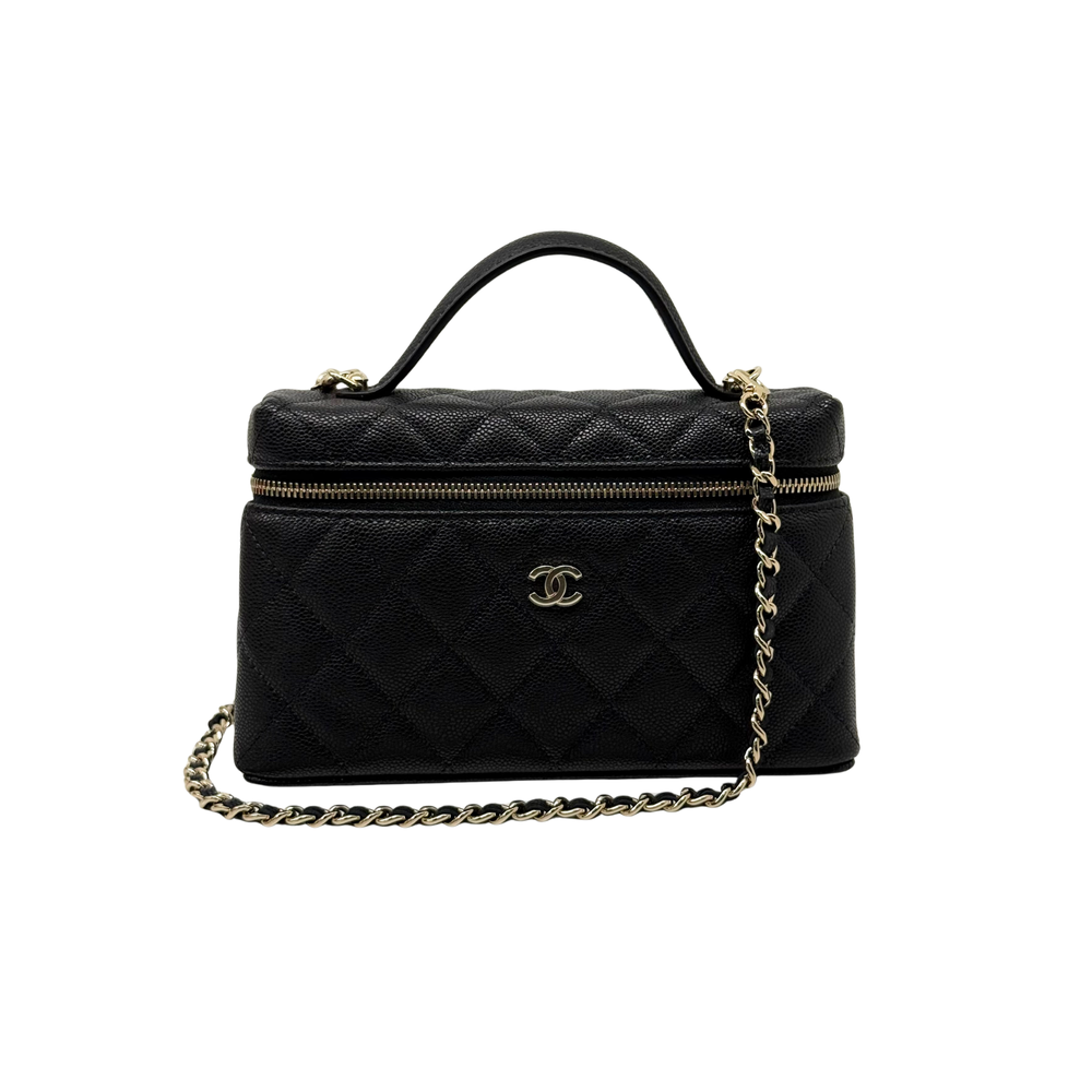 Black Chanel quilted leather handbag with top handle, gold zip, and chain strap