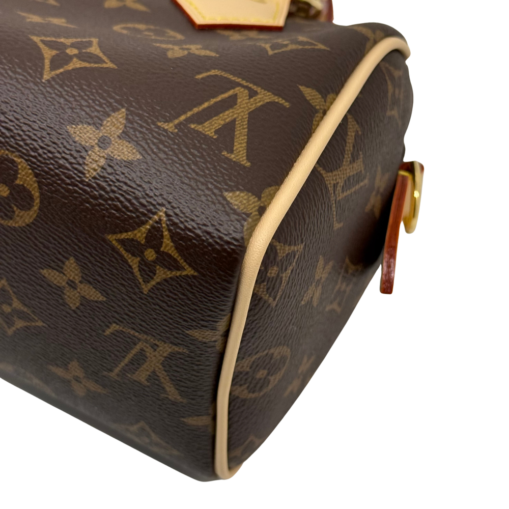 Louis Vuitton monogram cosmetic bag side view with beige edging and zipper pull