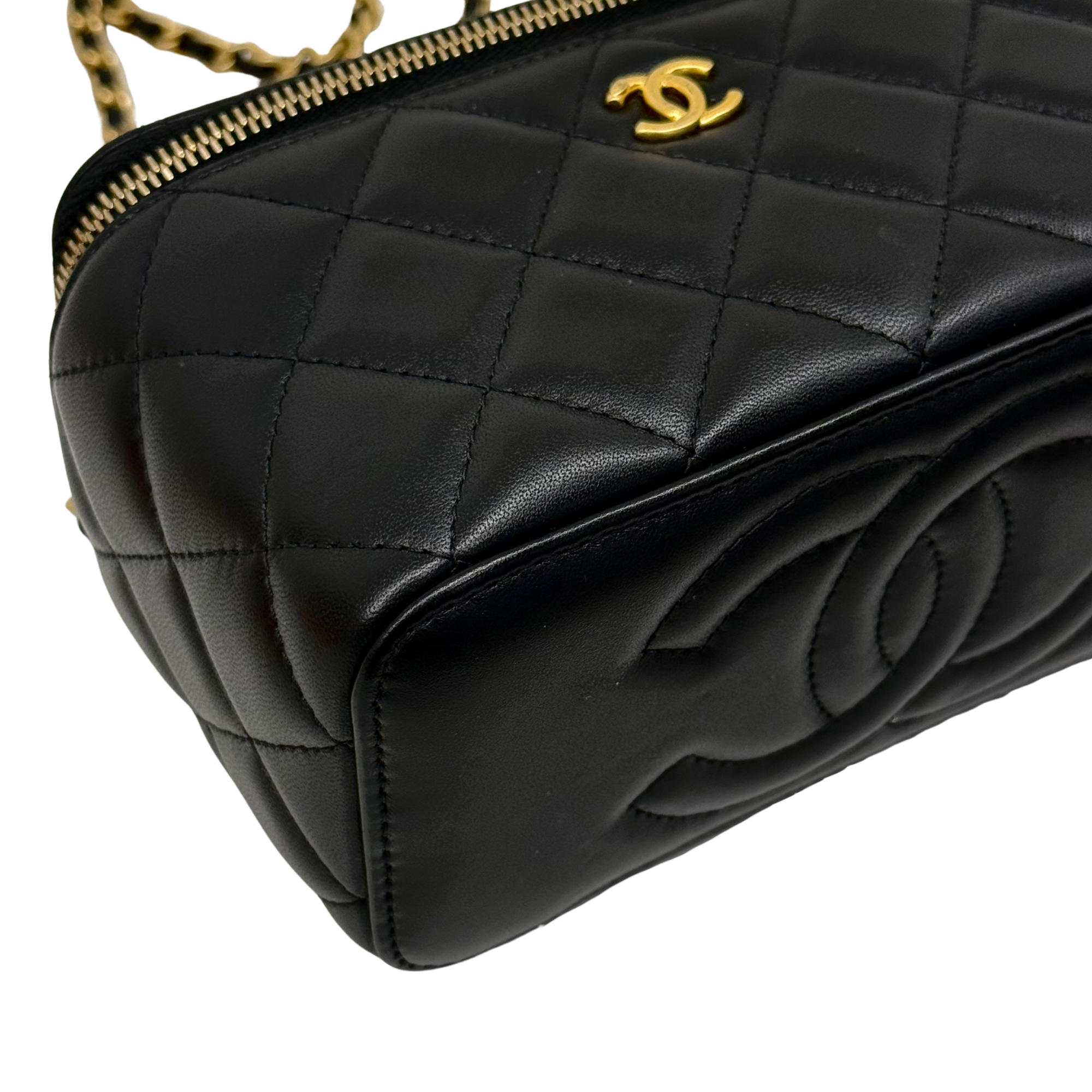 Black quilted leather front panel with CC logo, gold zipper, and chain strap