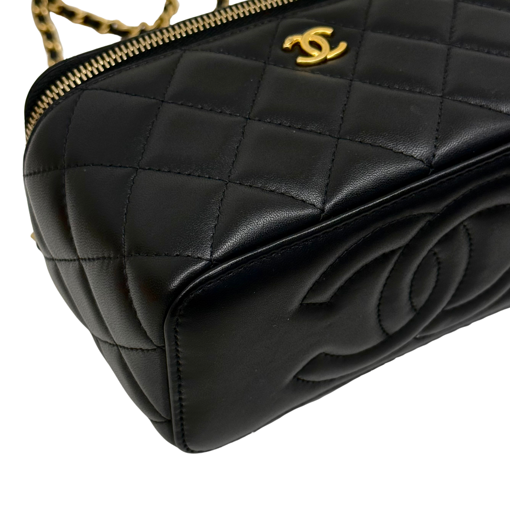 Black quilted leather front panel with CC logo, gold zipper, and chain strap
