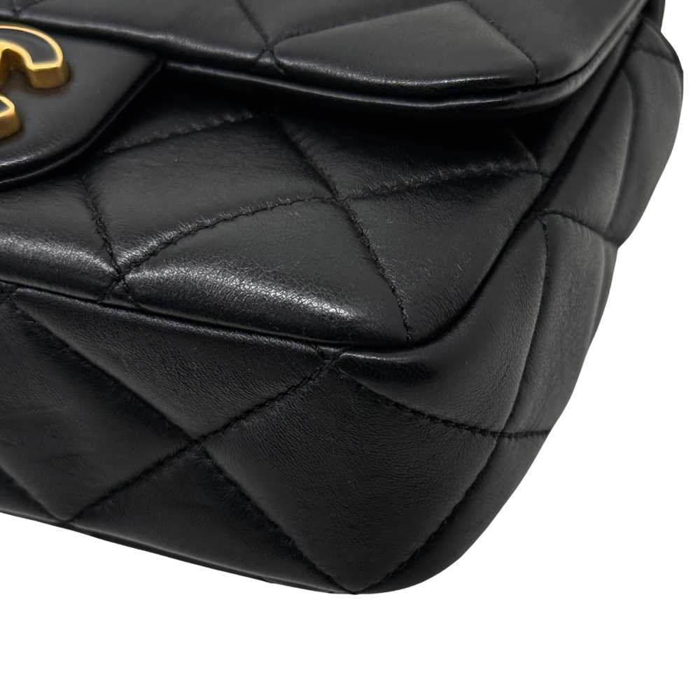Black quilted leather bag corner detail with stitched diamond panels