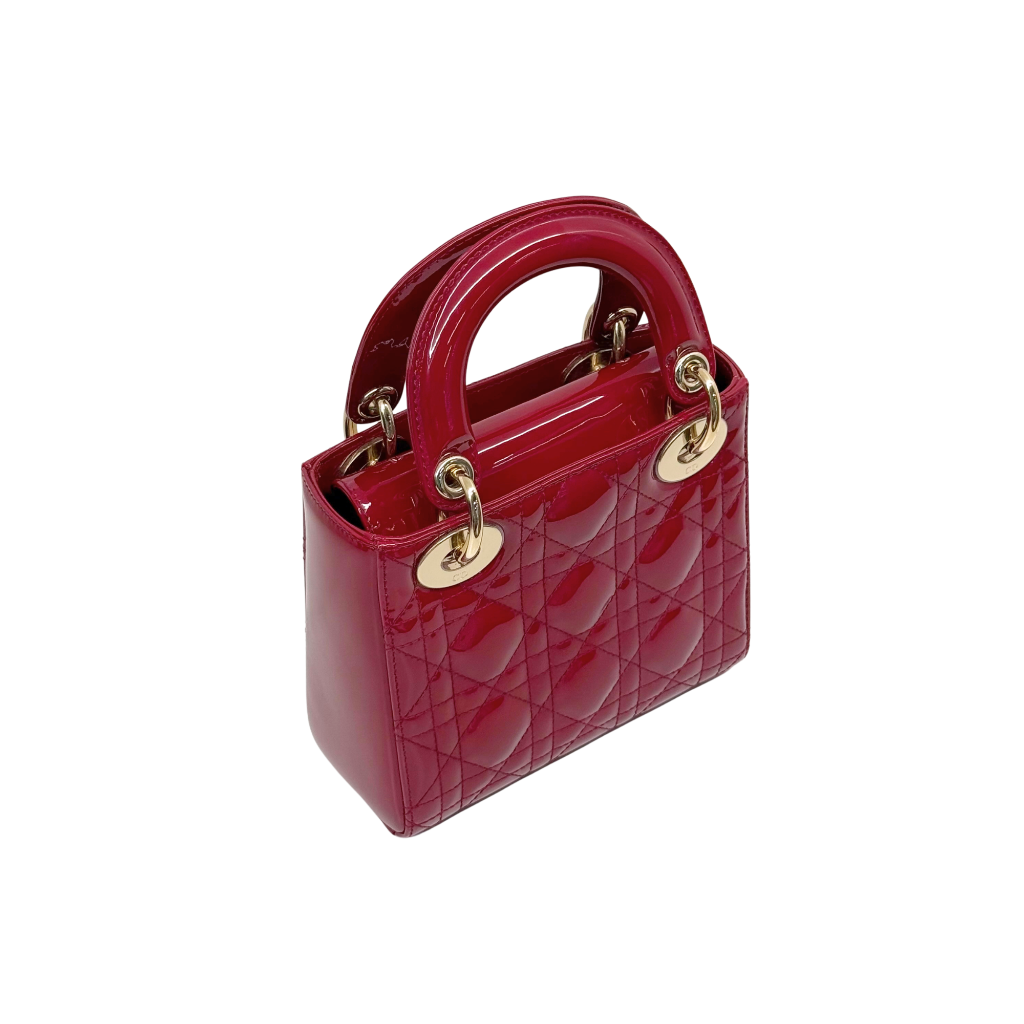 Red patent leather mini handbag with top handles and gold ring hardware