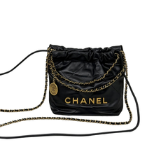Black quilted mini hobo crossbody bag with gold chain shoulder strap and CHANEL logo