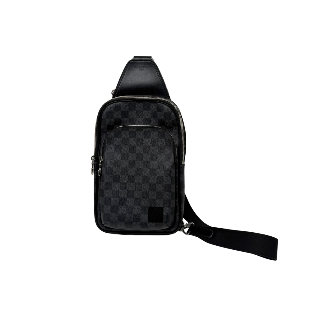 Dark checkered sling bag with front zip pocket and adjustable shoulder strap