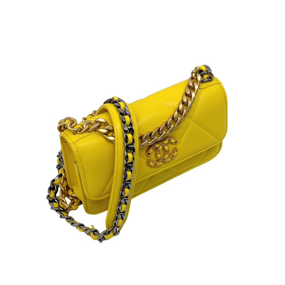 Yellow quilted crossbody bag with gold chain strap and logo emblem