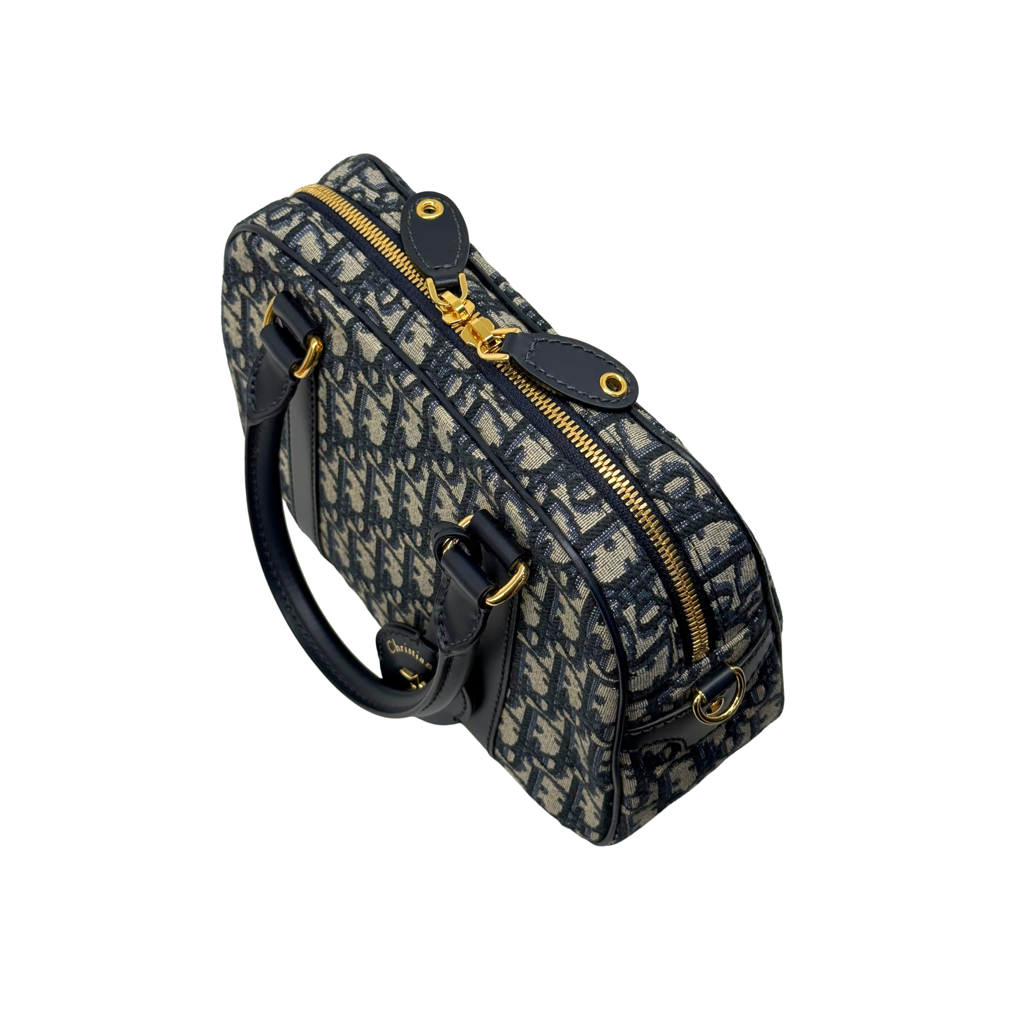 Navy and cream monogram handbag with side zip, top handle loops, and crossbody strap
