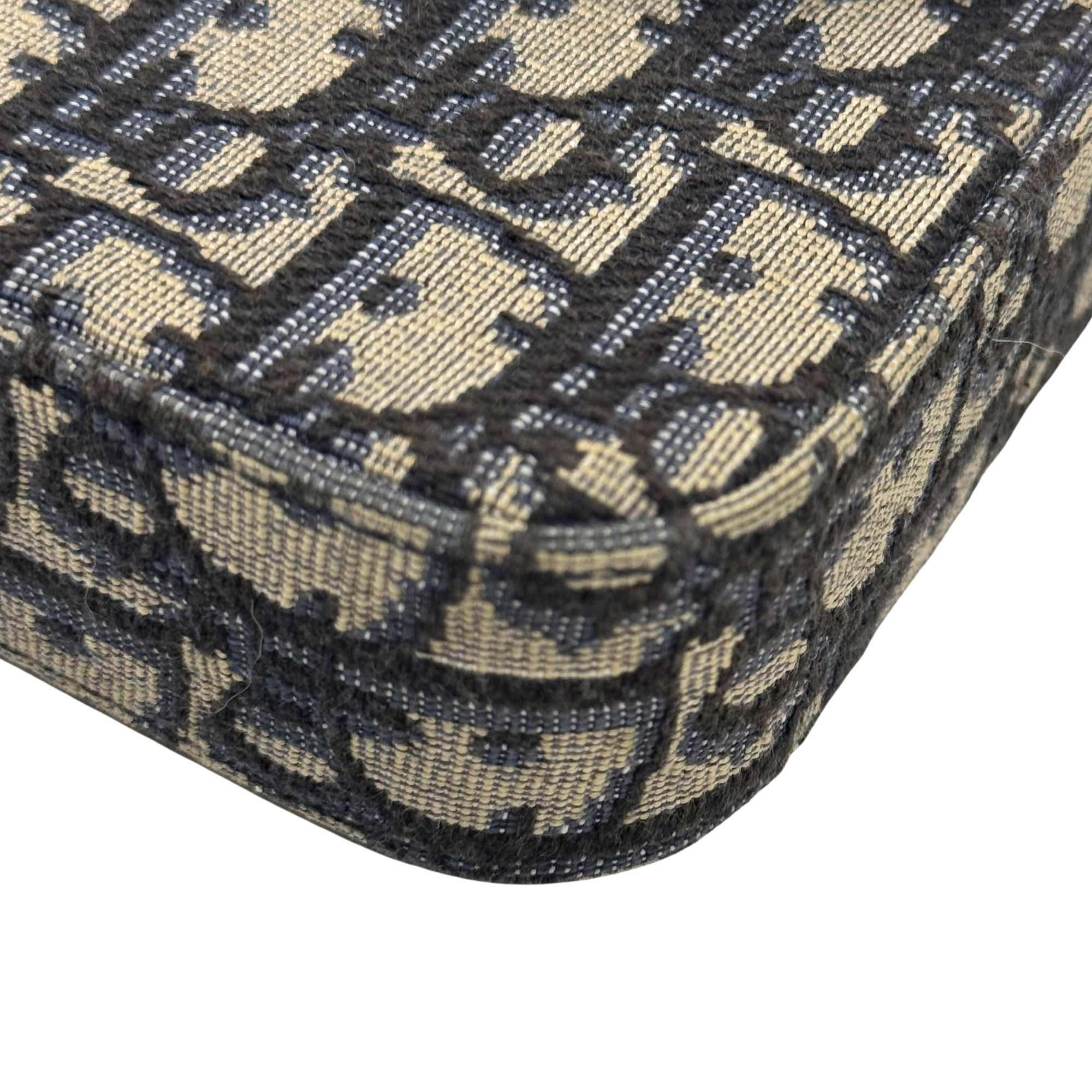 Dior monogram canvas detail with repeating pattern and visible top-stitching on edge