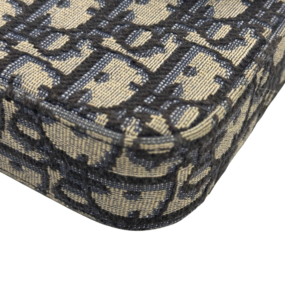 Dior monogram canvas detail with repeating pattern and visible top-stitching on edge
