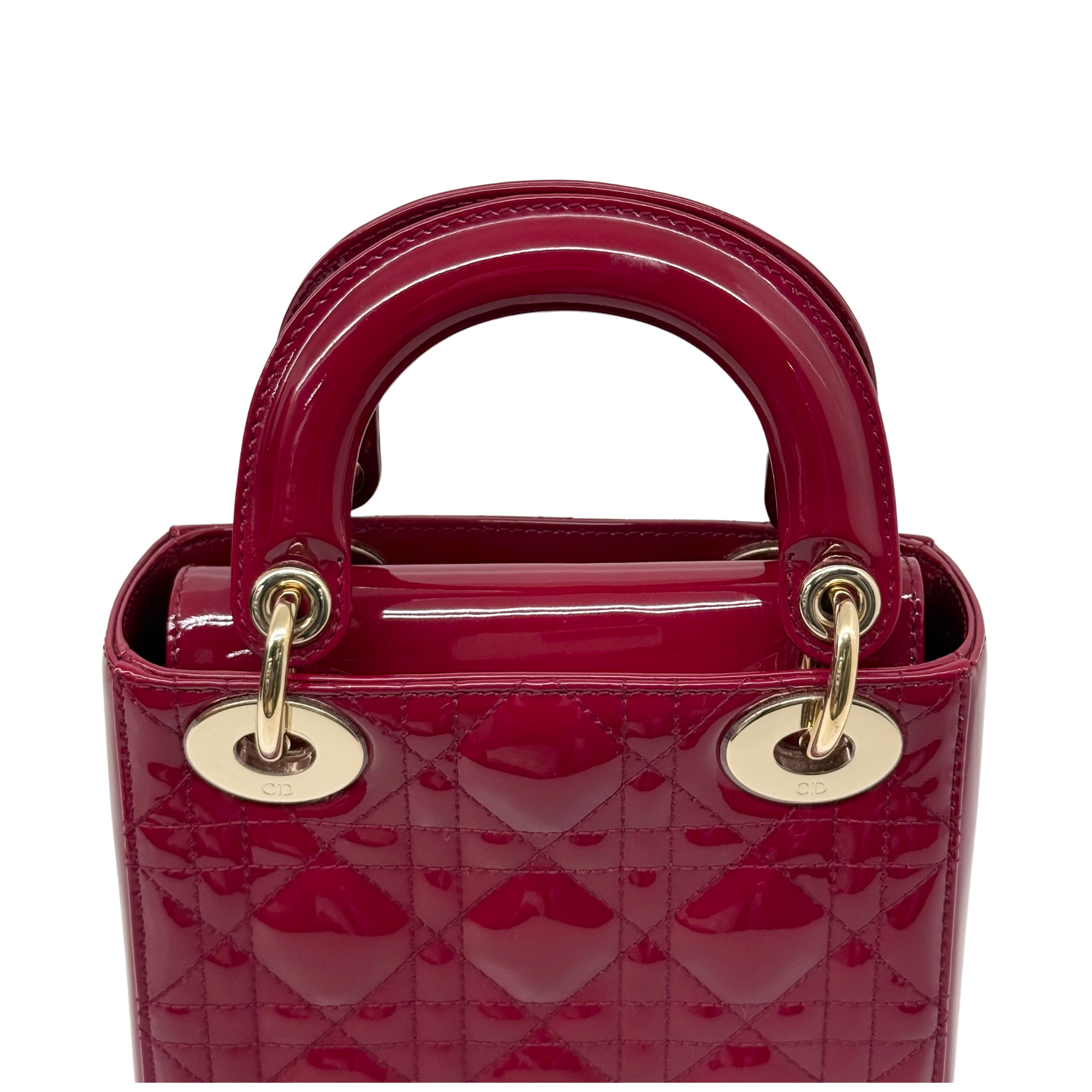 Red quilted patent top-handle handbag with gold rings and glossy finish