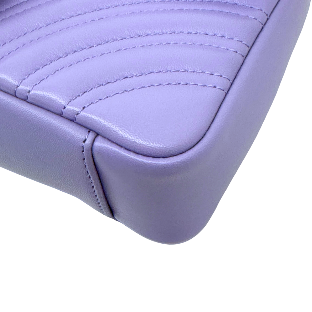 Lavender quilted leather bag with curved top stitching and structured corner