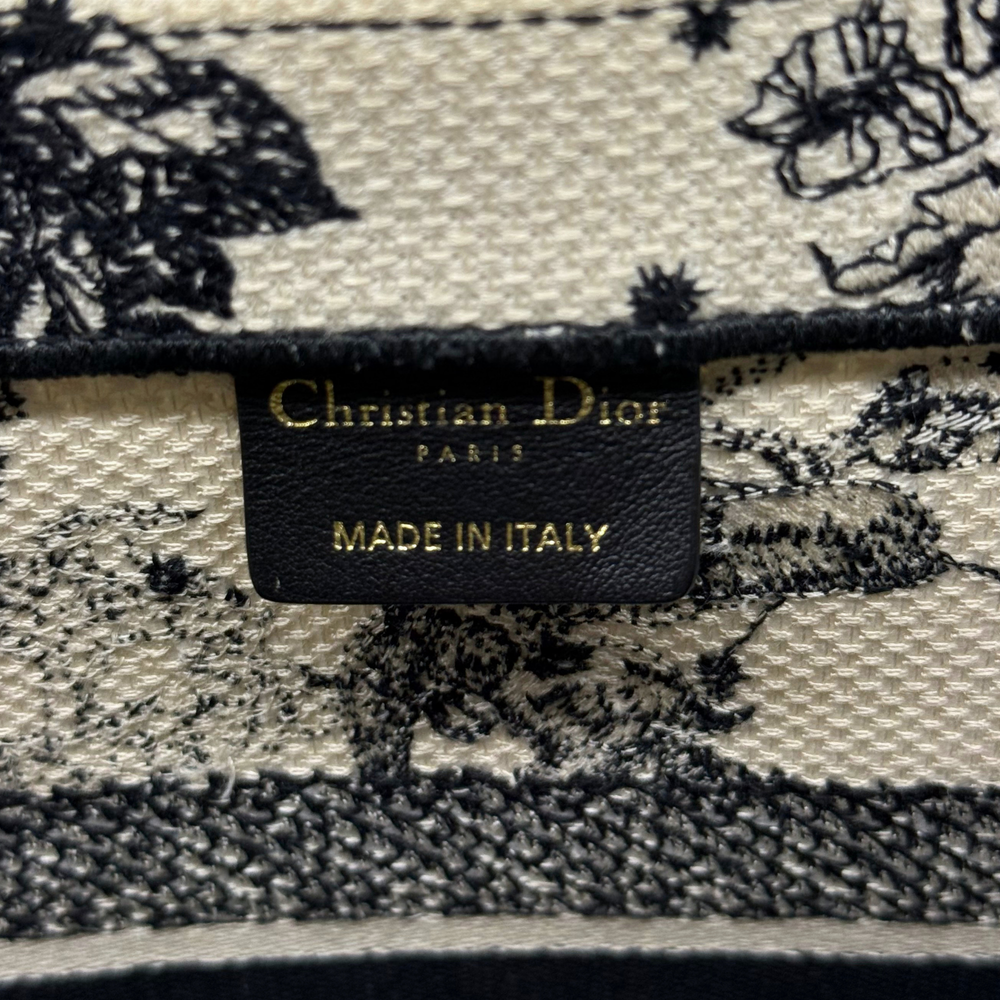 Dior canvas tote bag interior label reading Christian Dior and Made in Italy
