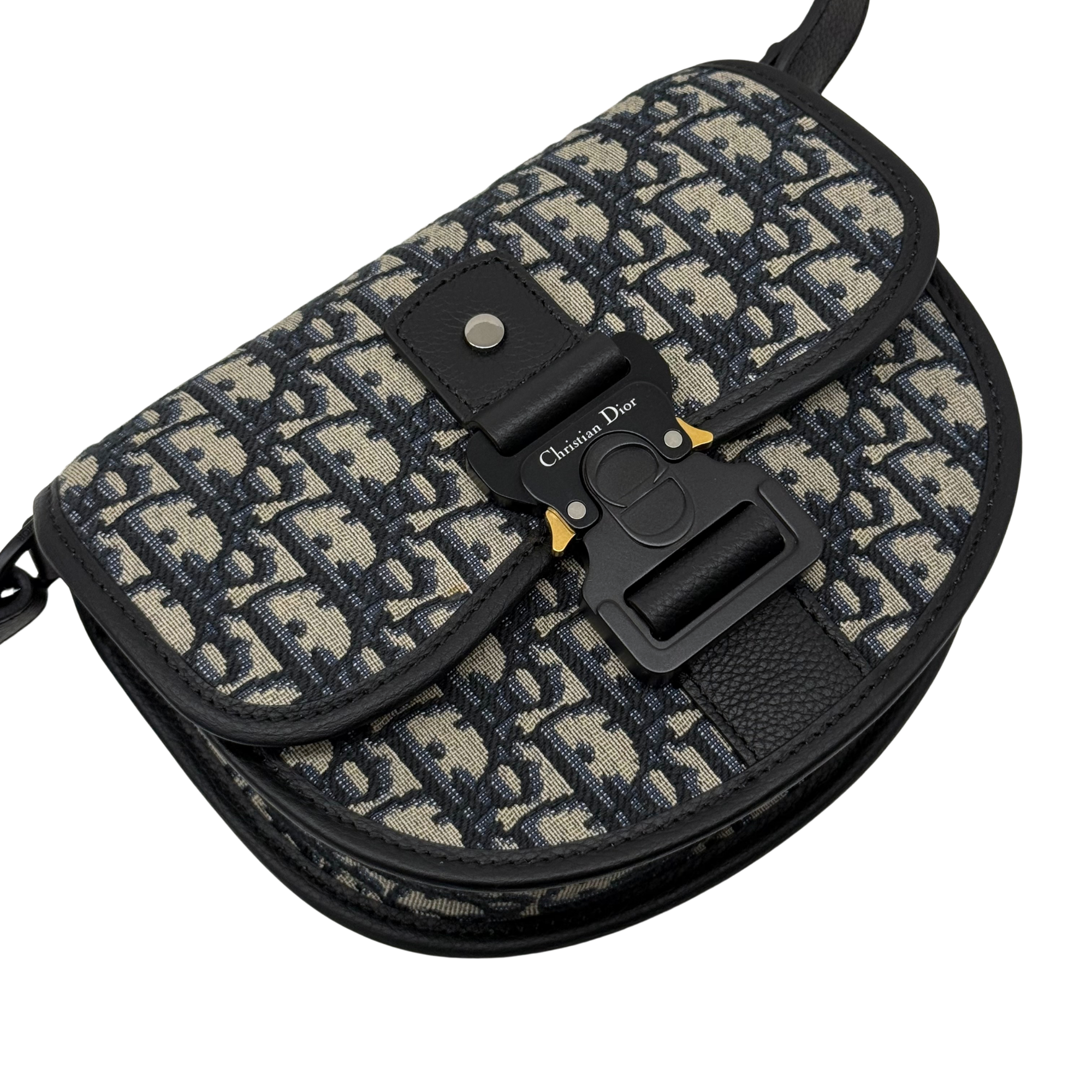 Dior crossbody bag with adjustable strap and front clasp on patterned canvas